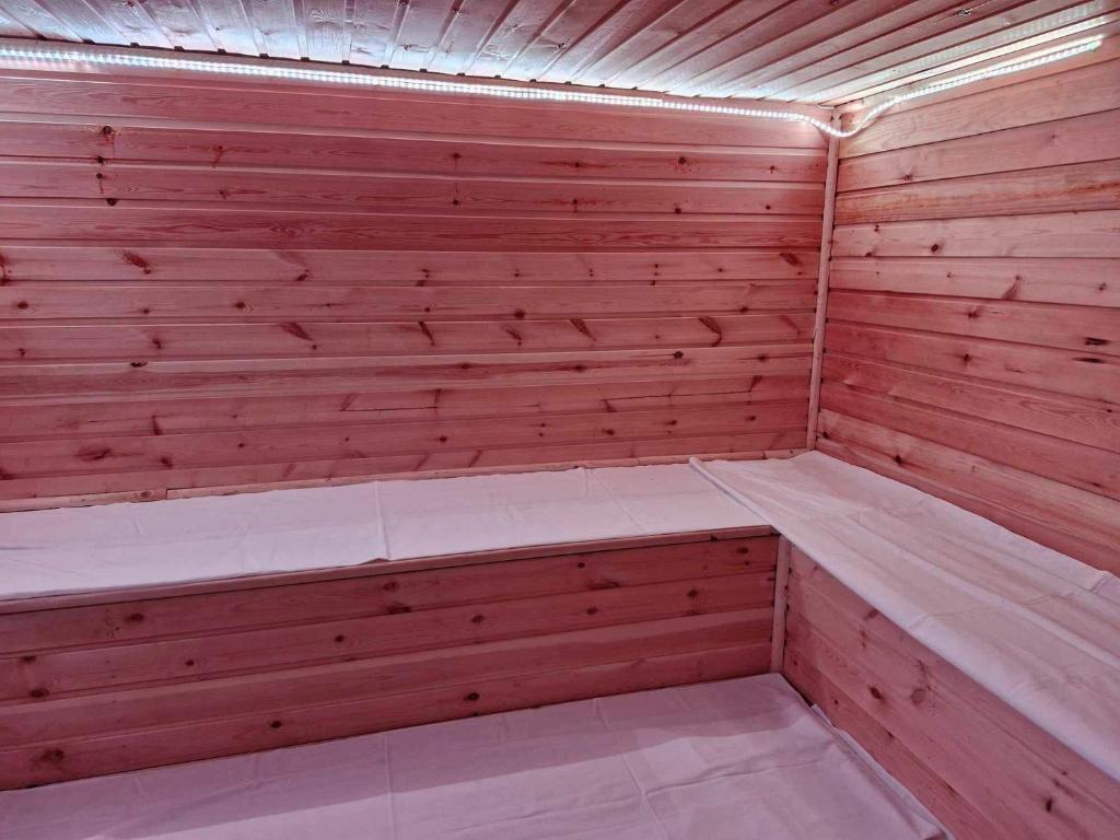 a sauna with a wooden paneled wall at Rózsa apartman in Odorheiu Secuiesc