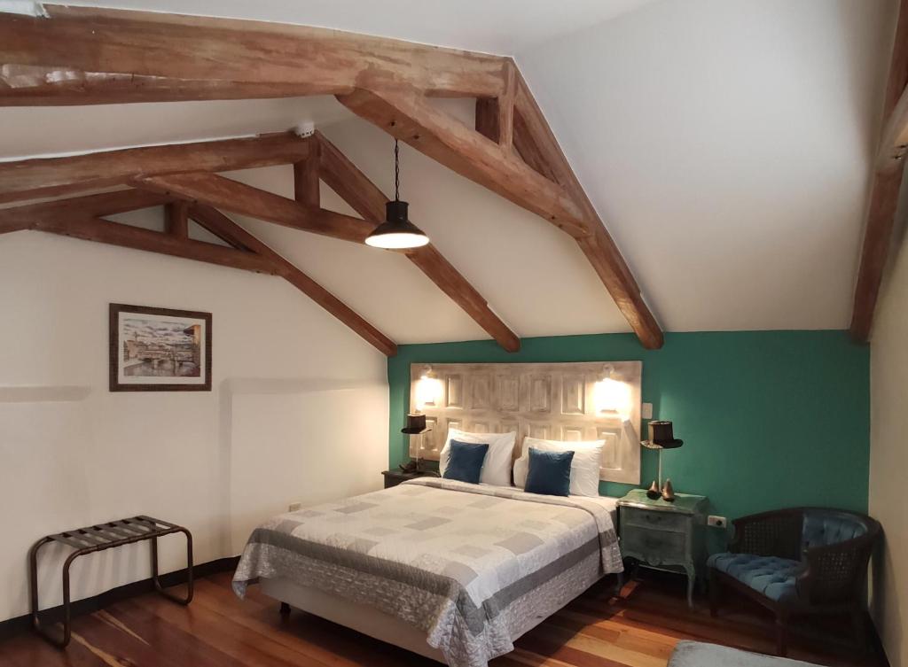 a bedroom with a bed and a green wall at Old Town Quito Suites, Heritage Boutique Hotel, Where Every Detail Tells a Story in Quito