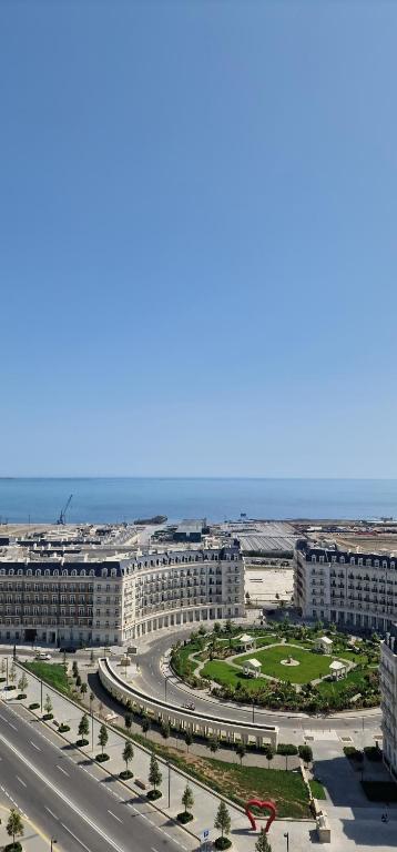 an aerial view of a city with a road and buildings at Baku White City-Seaview Luxury Apartment in Baku