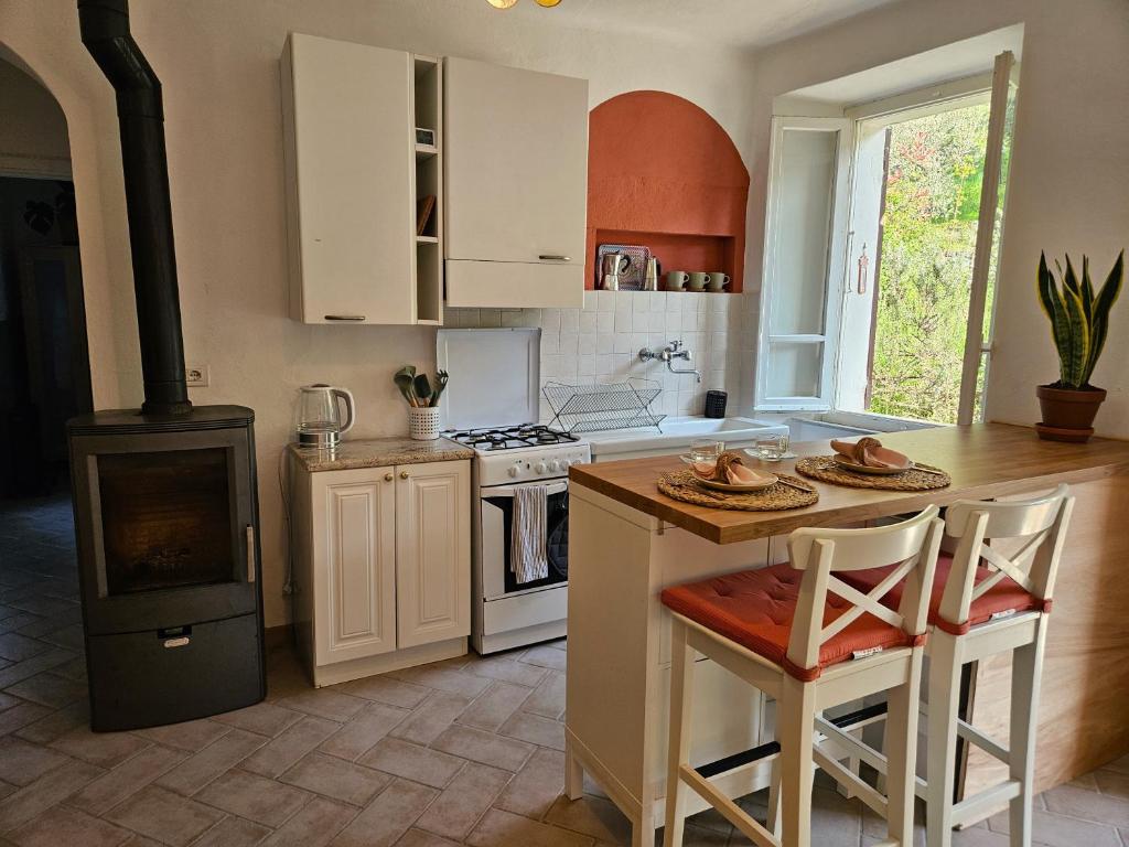 uma cozinha com um fogão e uma mesa com cadeiras em Casa di Marco em Irola