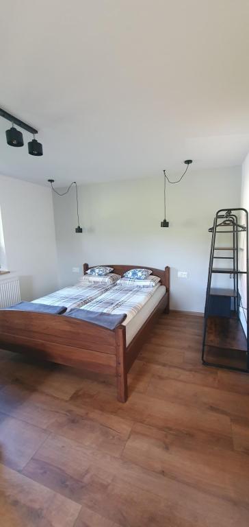 a bedroom with a bed and a ladder in a room at Beskidzki Zakątek Ustroń in Ustroń
