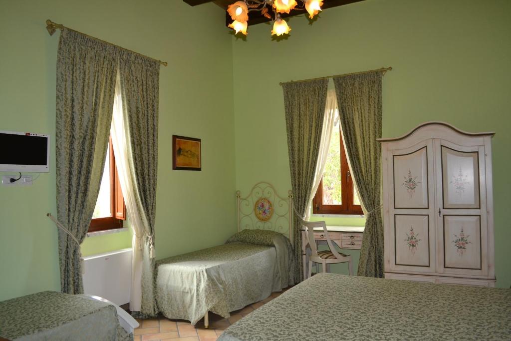Postel nebo postele na pokoji v ubytování Agriturismo La Palazza