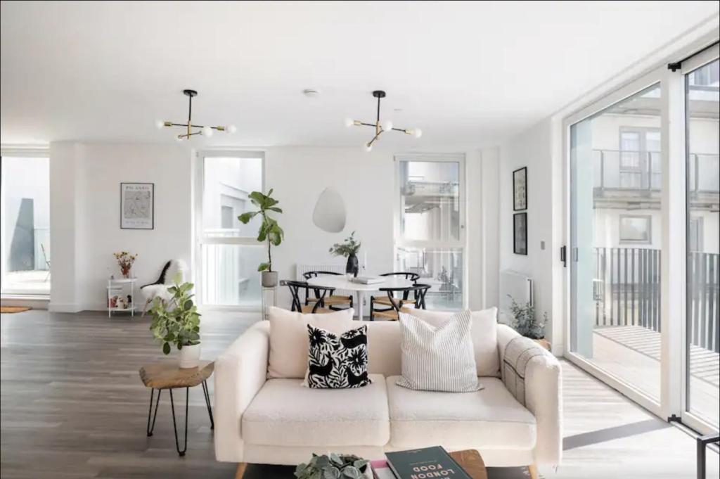a living room with a white couch and a table at Scandi Style Flat in London with Private Terrace in London