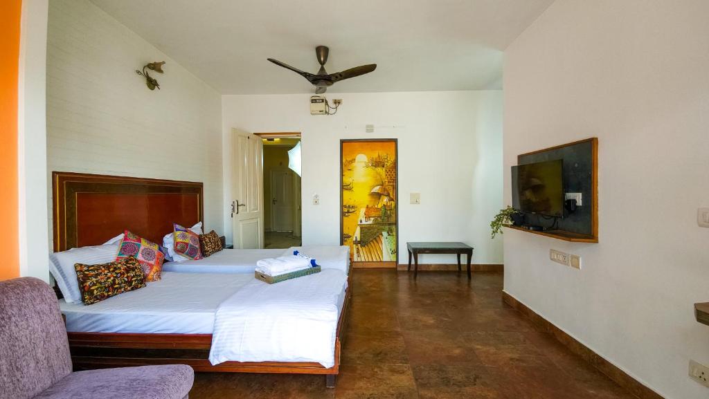 Postel nebo postele na pokoji v ubytování Prakash Kutir B&B