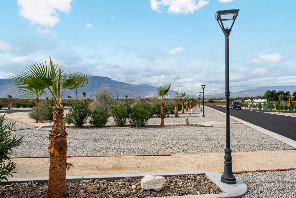 a street light on the side of a road with palm trees at RV51-Lot-Paradise RV Park in Desert Hot Springs