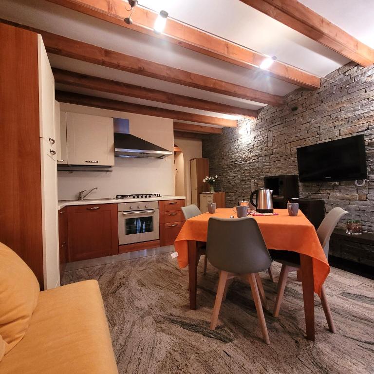 een keuken en eetkamer met een tafel en stoelen bij Il Cortiletto Mountain Lake Iseo Hospitality in Costa Volpino