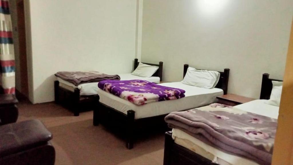a room with two beds and a couch at KAPEL Inn HOTEL in Nagir