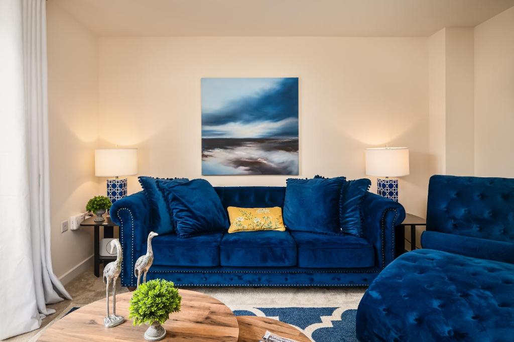 a living room with a blue couch and a table at Poppy House - Coastal Getaway 2 Bedroom in Scalby in Scalby