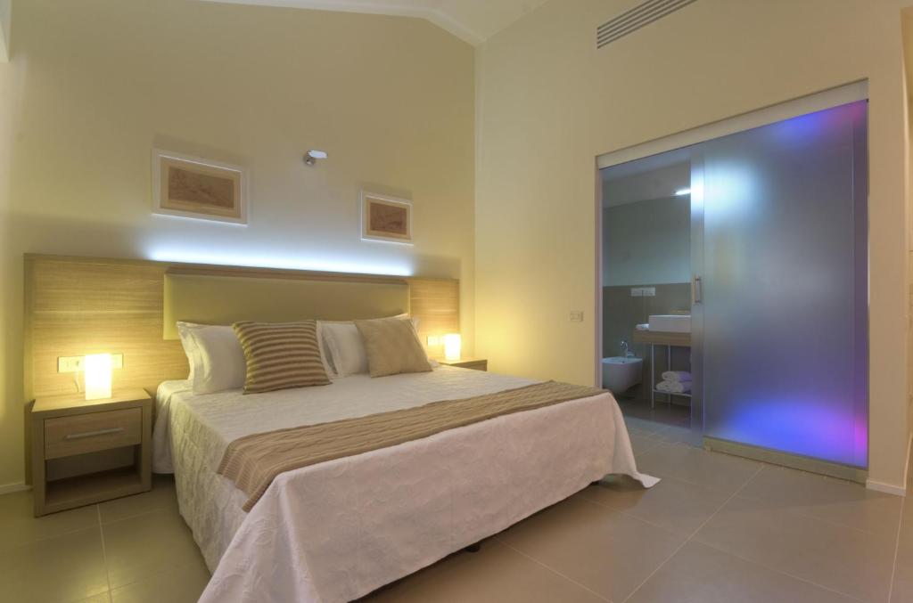 Postel nebo postele na pokoji v ubytování Palazzo Ruschioni Boutique Hotel