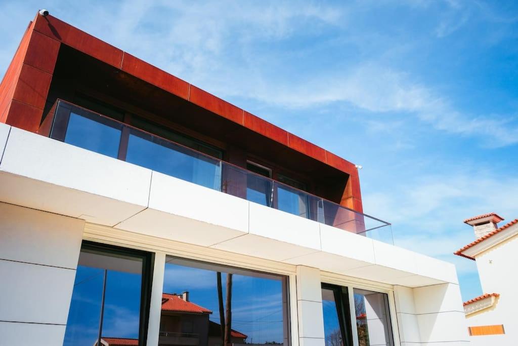 a red and white building with glass windows at Marlages House in Lavra