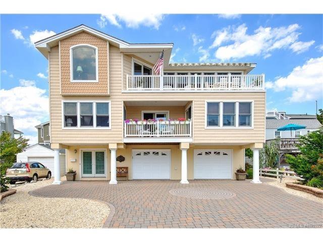 a large house with a balcony on top of it at Peachbrook, Llc in Brant Beach