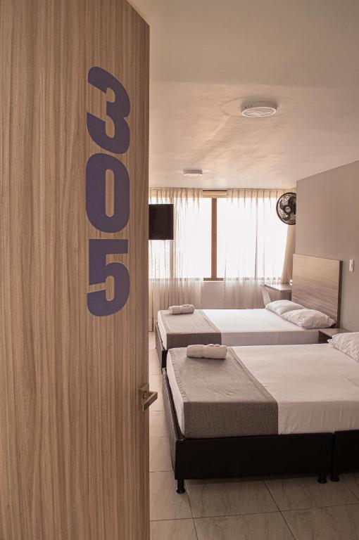 Postel nebo postele na pokoji v ubytování HOTEl INTER DEL CAFE