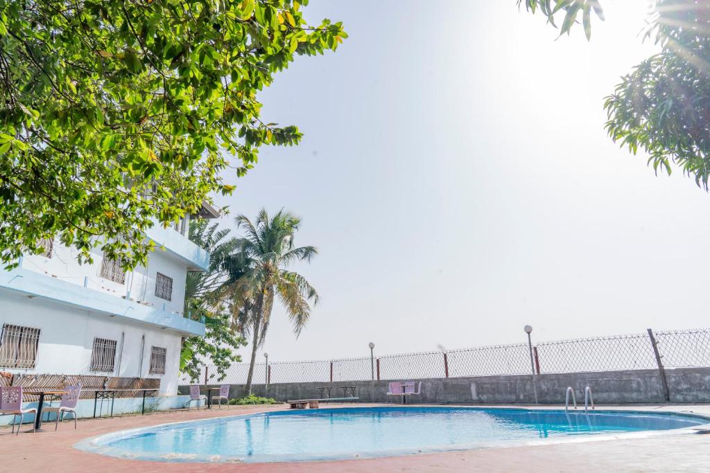 une piscine en face d'un bâtiment dans l'établissement Hotel Azur Conakry, à Conakry