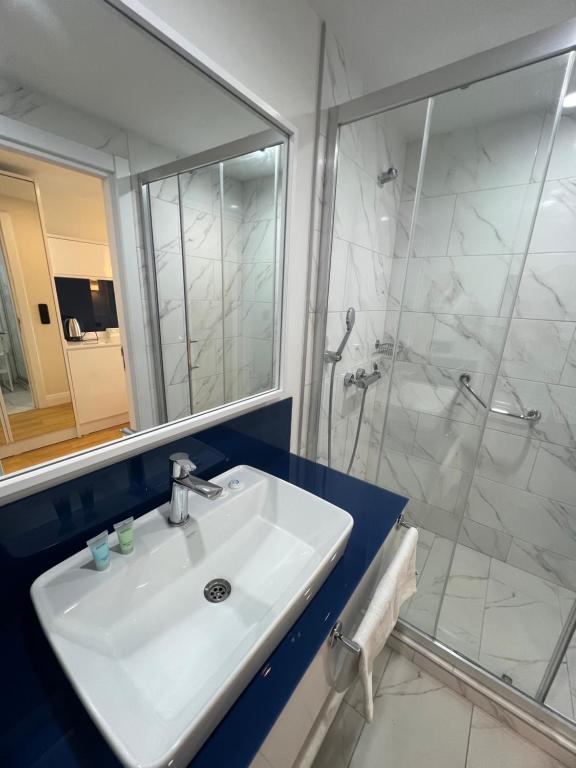 a bathroom with a sink and a shower at Orbi City HOTEL in Batumi