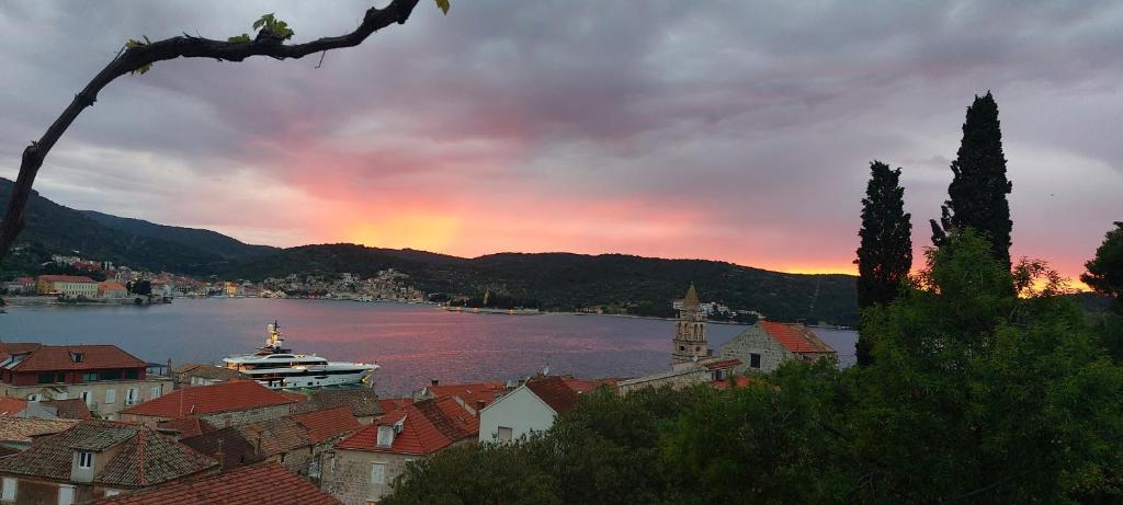 a view of a city with a rainbow in the sky at Stunning view-Maleni in Vis