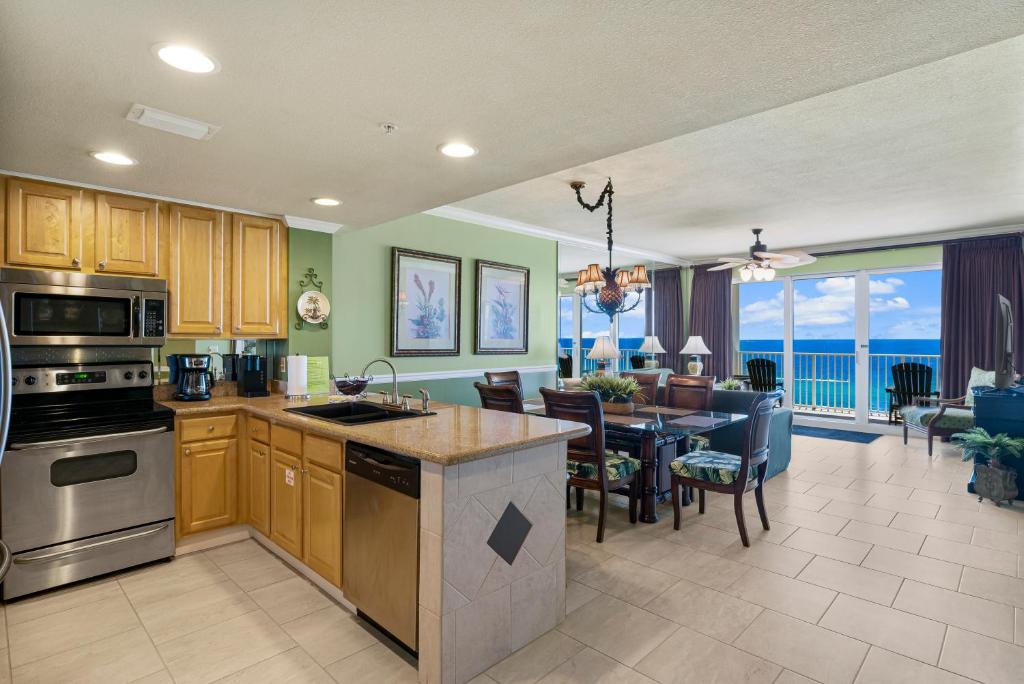 a kitchen and dining room with a view of the ocean at Beachfront Bliss Luxe 3BR Condo at Marisol Complex in Panama City Beach