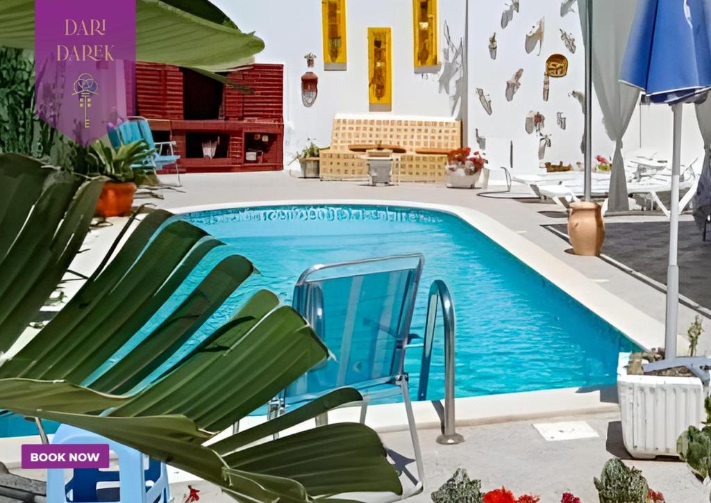 uma piscina com uma cadeira e um macarrão de piscina em Verte Casa em Hammamet