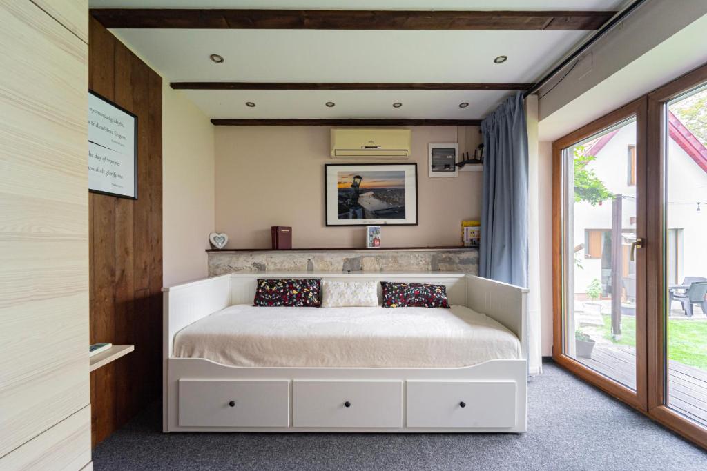 a bedroom with a bed and a window at B48 Woodhause in Törökbálint