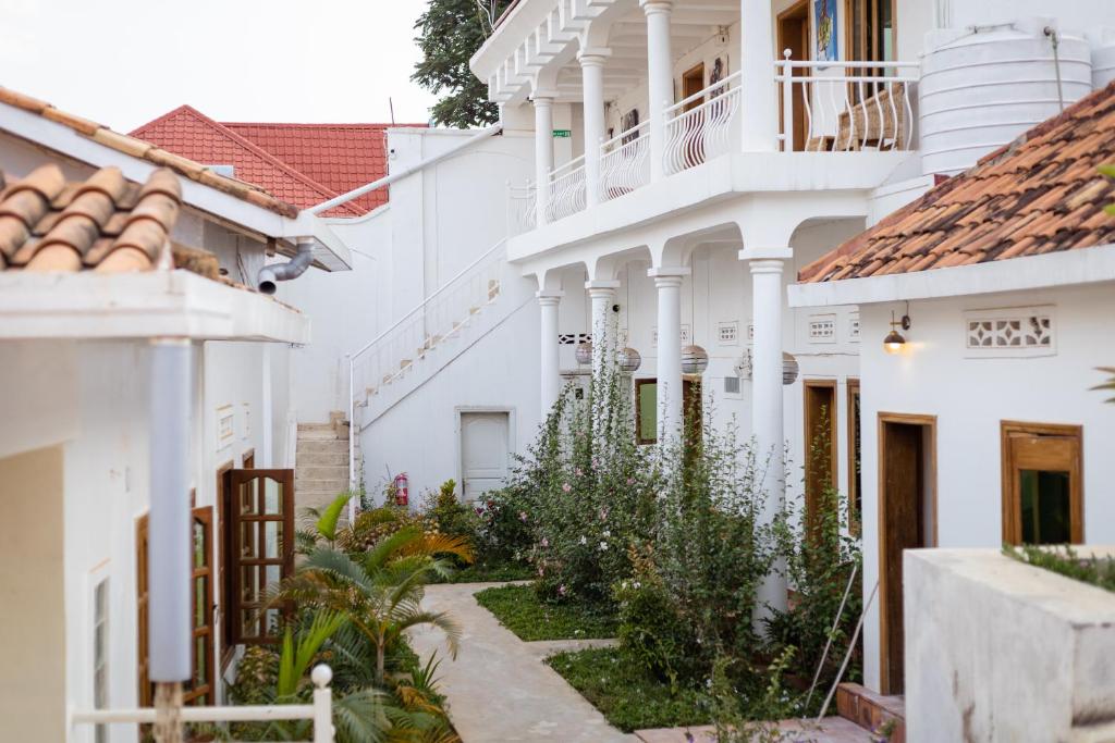 a courtyard of a white building with plants at The Nest in Kigali