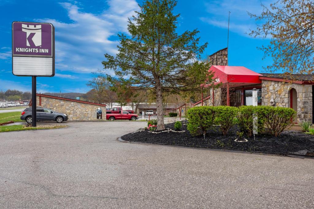 a parking lot with a sign in front of a building at Knights Inn Ashland in Ashland