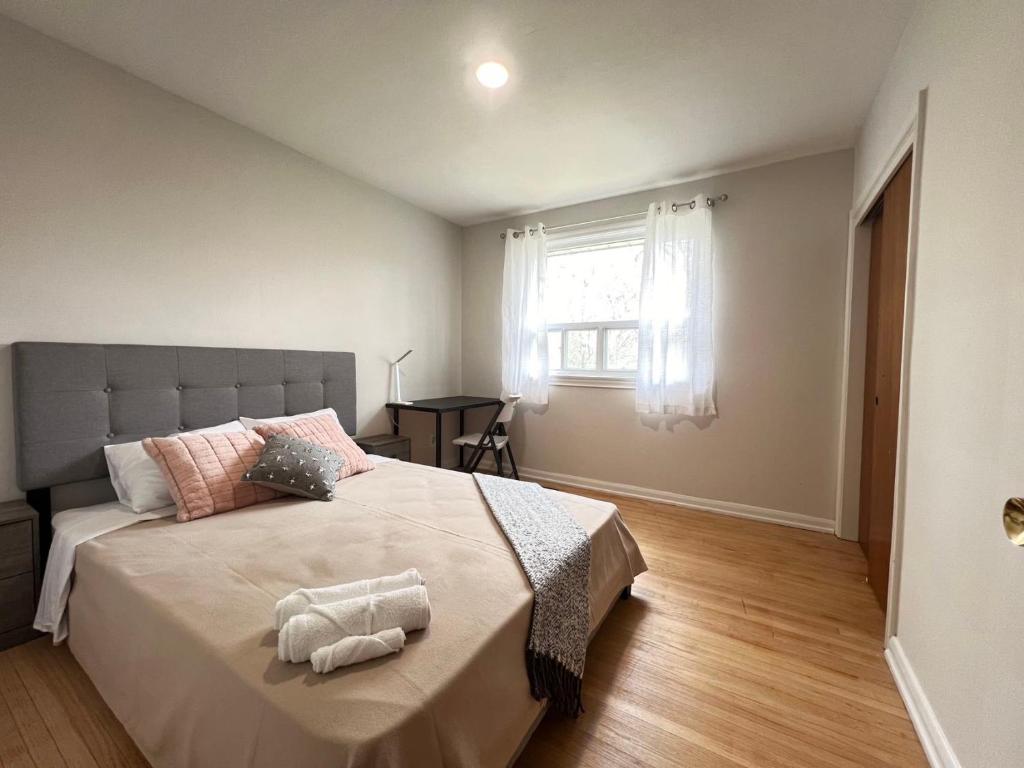a bedroom with a large bed and a window at ViHome-Queen bedroom near Don Mills Dvp & 401 in Toronto