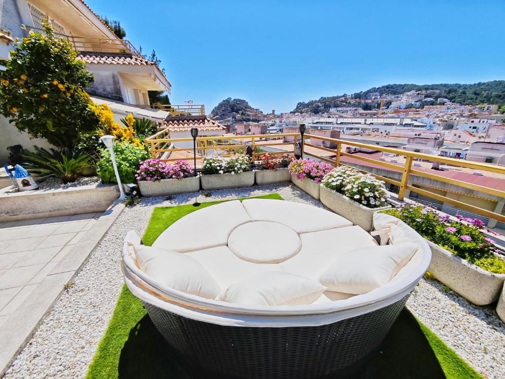 a balcony with a table and a view of the city at Apartment Luna Tossa De Mar 5mins walking to the beach with sea and castle view big terrace in Tossa de Mar