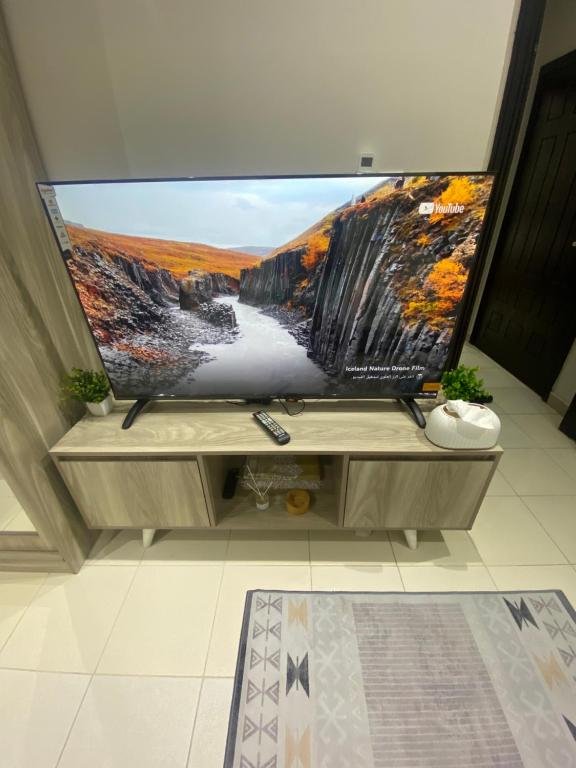 a large flat screen tv sitting on a entertainment center at شقة مفروشة in Jeddah