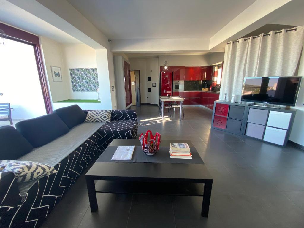 a living room with a couch and a coffee table at Luxury view apartment 10min from Athens airport in Koropi