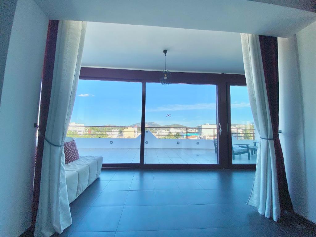 a living room with a large window with a view at Luxury view apartment 10min from Athens airport in Koropi