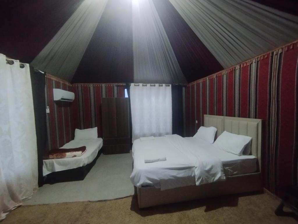 a bedroom with two beds in a tent at Waid Rum Jordan Jordan in Wadi Rum