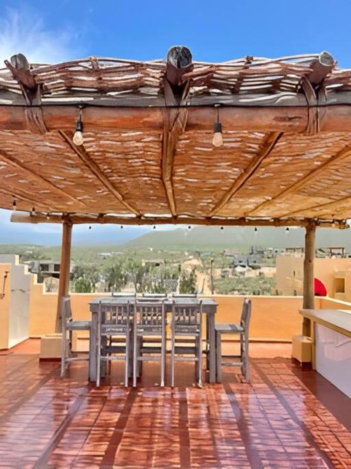a patio with a table and chairs on a roof at 2C Stunning Top Floor Unit, Breathtaking Ocean Views in San Carlos