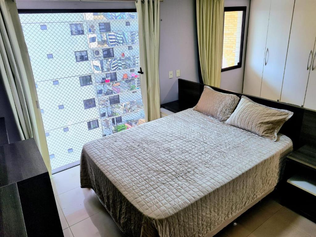 Tempat tidur dalam kamar di Royal Duplex Umarizal