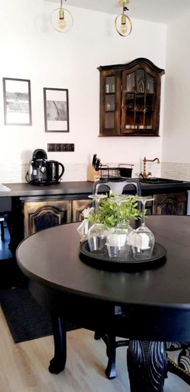 a kitchen with a table with plants on it at Gold Apartament in Wałbrzych