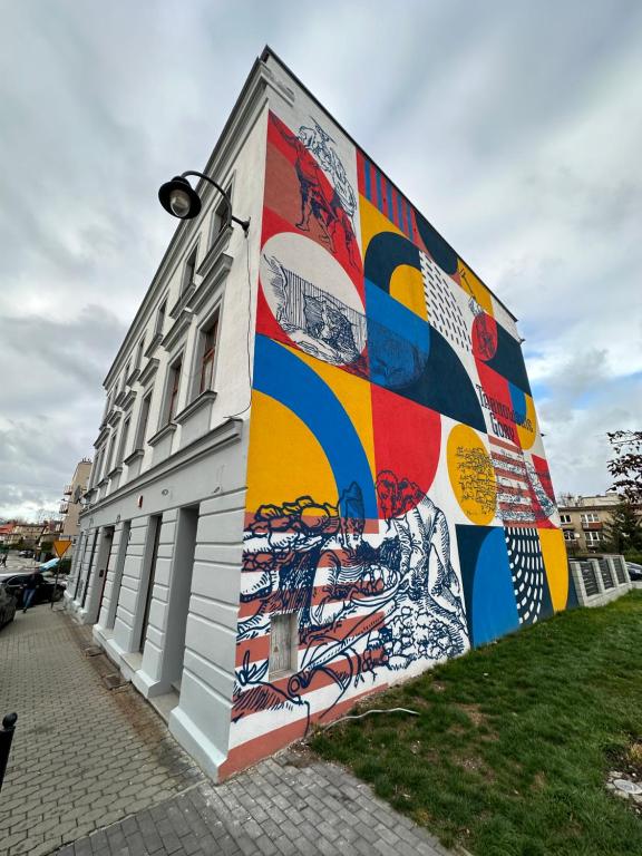 a building with a mural on the side of it at Apartament Opolska 5 in Tarnowskie Góry