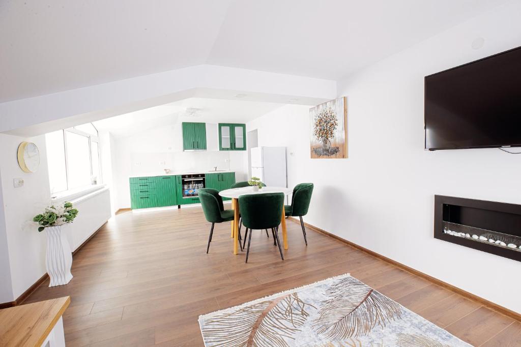 a living room with a table and green chairs at GreenBoxApartment in Kyustendil