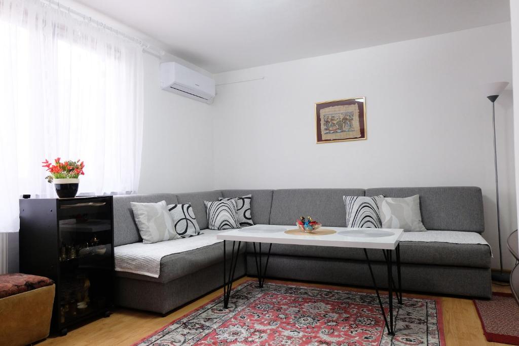 a living room with a couch and a table at Ammy apartment in Sarajevo