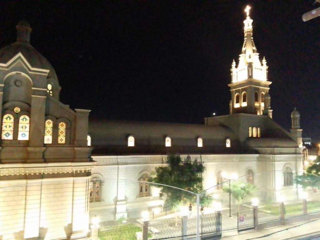 a large building with a clock tower at night at Hamuy's Lodge in Ica