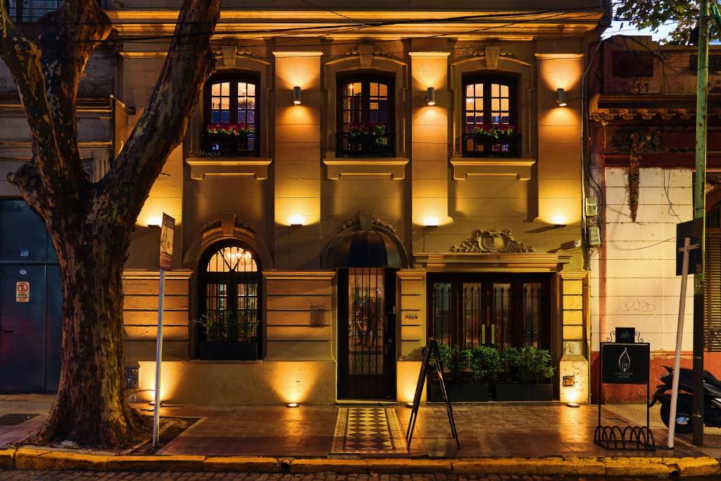 a building with a tree in front of it at Miravida Soho Hotel & Wine Bar in Buenos Aires