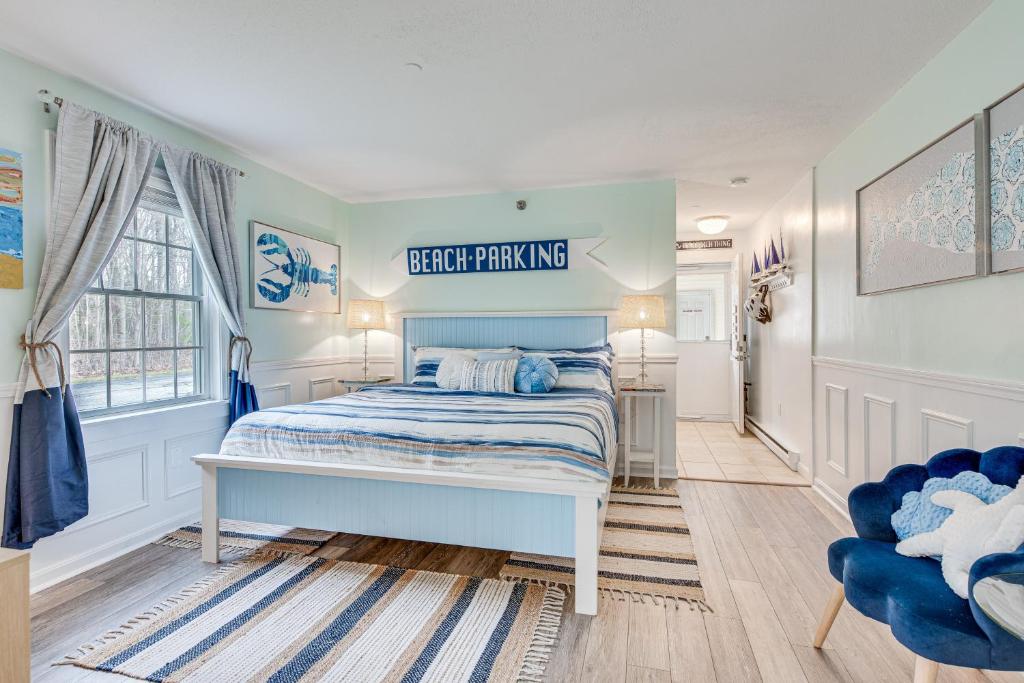 a bedroom with a bed and a blue chair at Livin Wells Retreat, 2 Mi to Drakes Island Beach in Wells