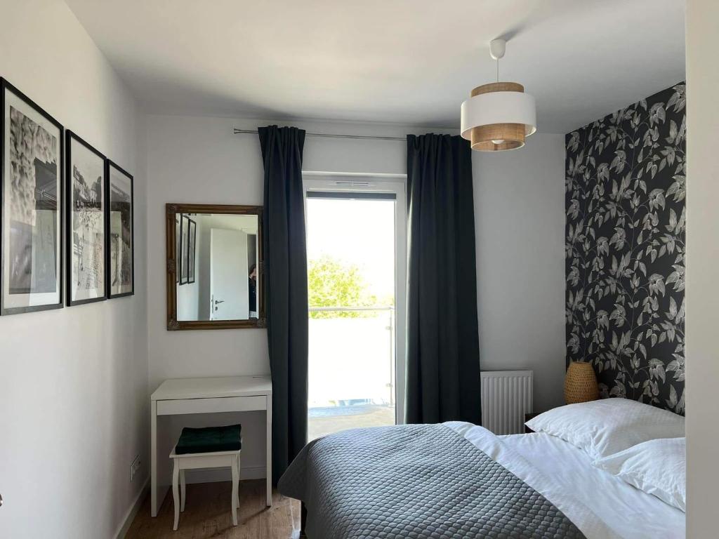a bedroom with a bed and a window at Apartament u Kasi in Sandomierz