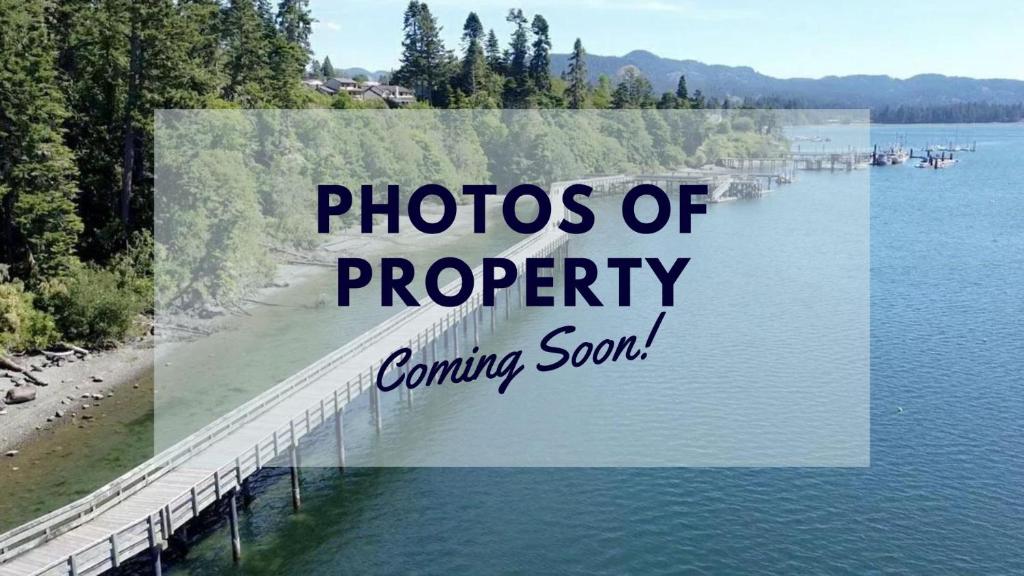 a picture of a pier on a lake with the words photos of property coming soon at Cozy Cabin Suites, Sooke, Bc in Sooke