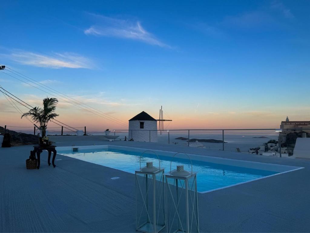 a swimming pool with a person standing next to it at O Mylos in Ermoupoli
