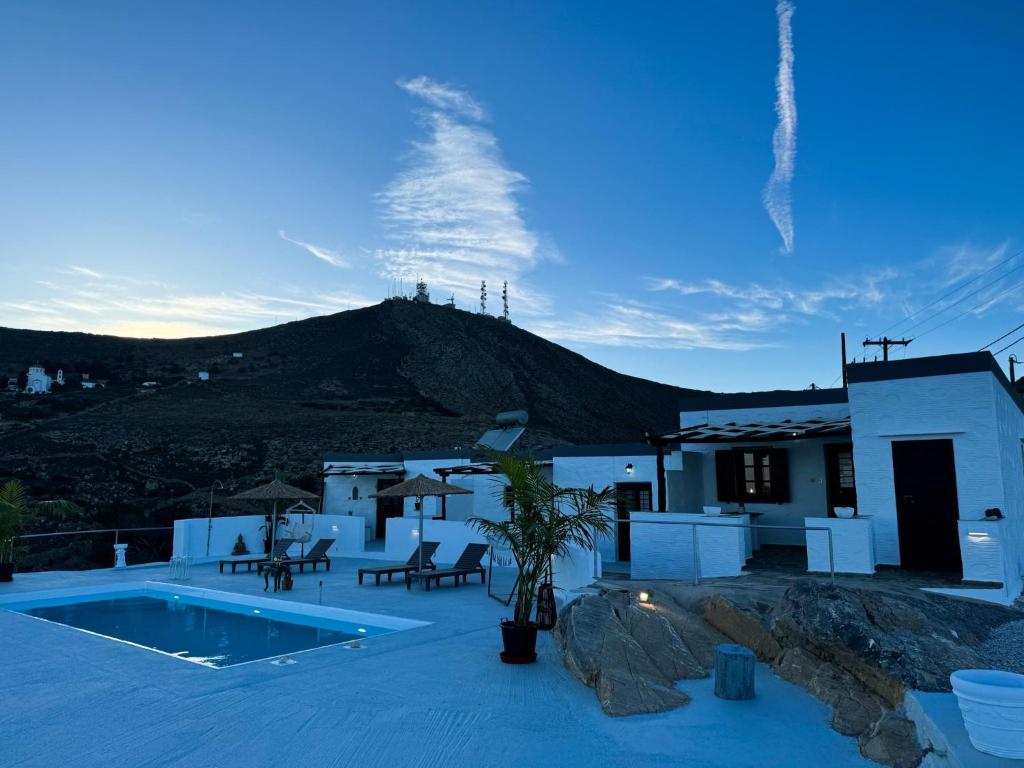 a villa with a swimming pool and a mountain at O Mylos in Ermoupoli