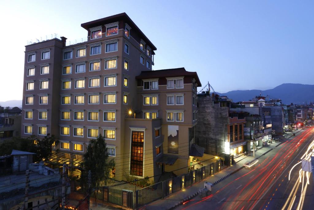 a tall building on a city street at night at Hotel Shambala in Kathmandu