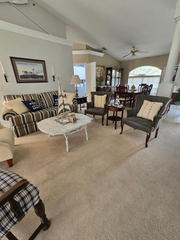 a living room with a couch and a table at Peaceful Lakeside Retreat in Winter Haven
