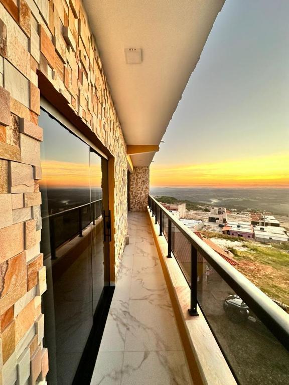 a balcony with a view of a city at ECOLETRAS APART - SÃO THOMÉ DAS LETRAS Mg in São Thomé das Letras