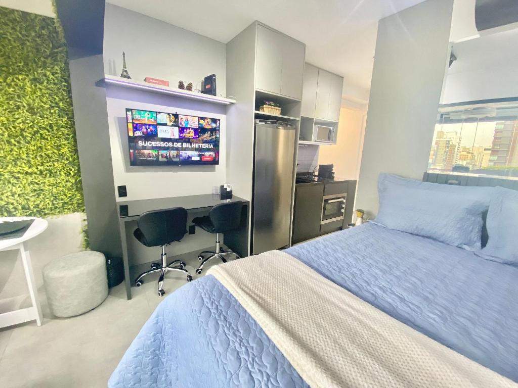 a bedroom with a bed and a desk and a computer at Ap luxo Jardins Pamplona cd 1111 in Sao Paulo
