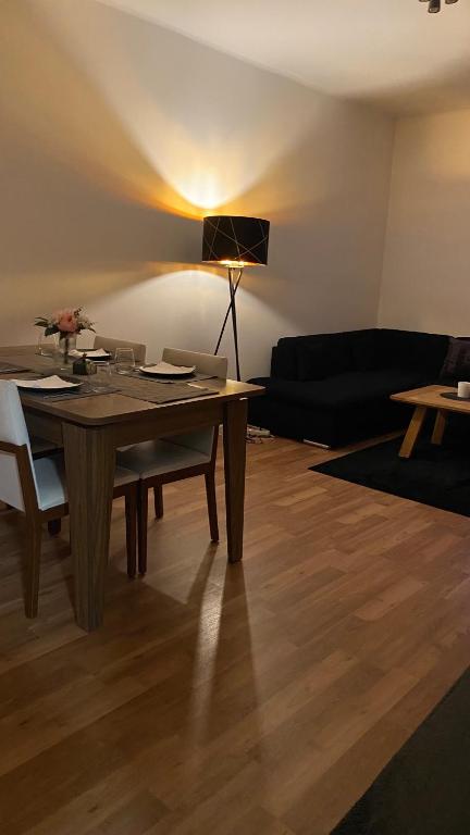a living room with a table and a couch at ZE City Apartments in Hannover
