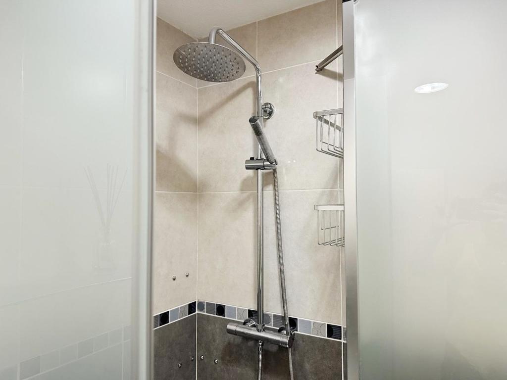 a shower with a glass door in a bathroom at Relaxing Ocean View, Spacious Art Apartment With Large Terrace, Near Best Costa Adeje Beaches in Adeje