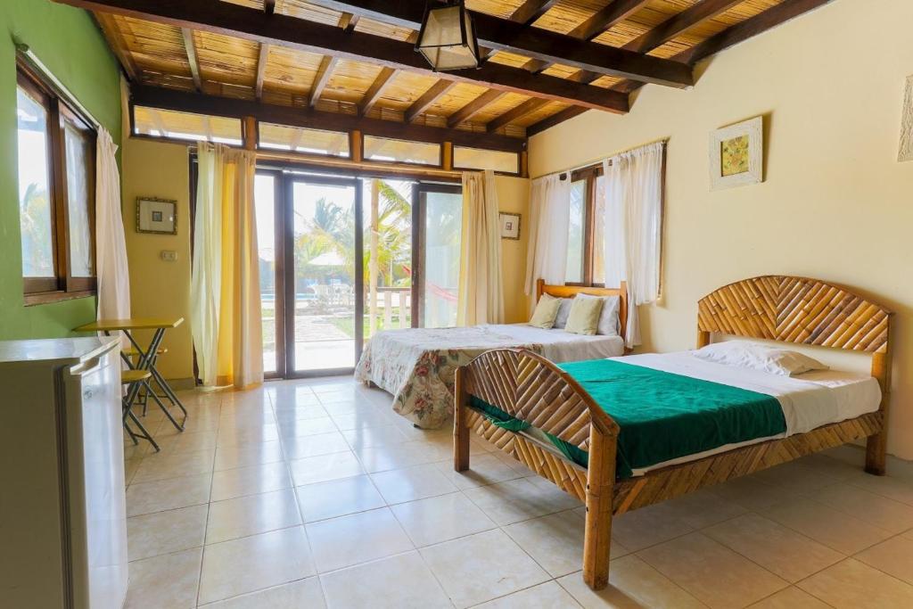 Postel nebo postele na pokoji v ubytování Punta Pacífico Bungalows Máncora